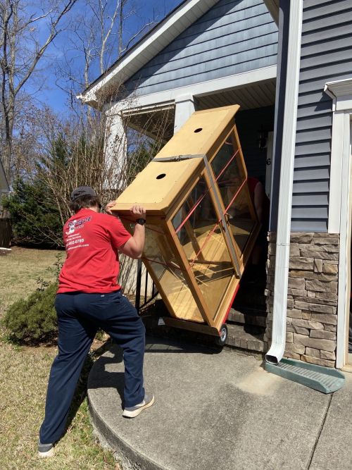 Budget Movers moving truck in front of house.